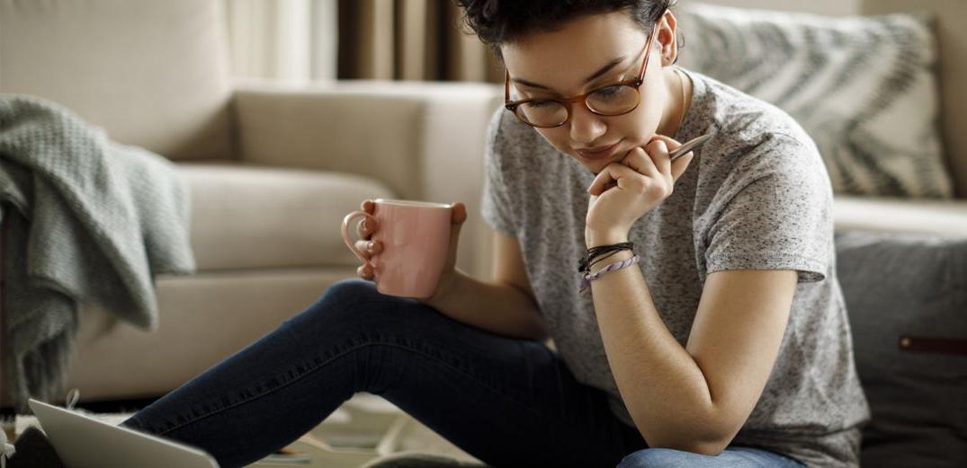 A Gen Z woman uses the Patelco Mobile App to access her credit card statement.